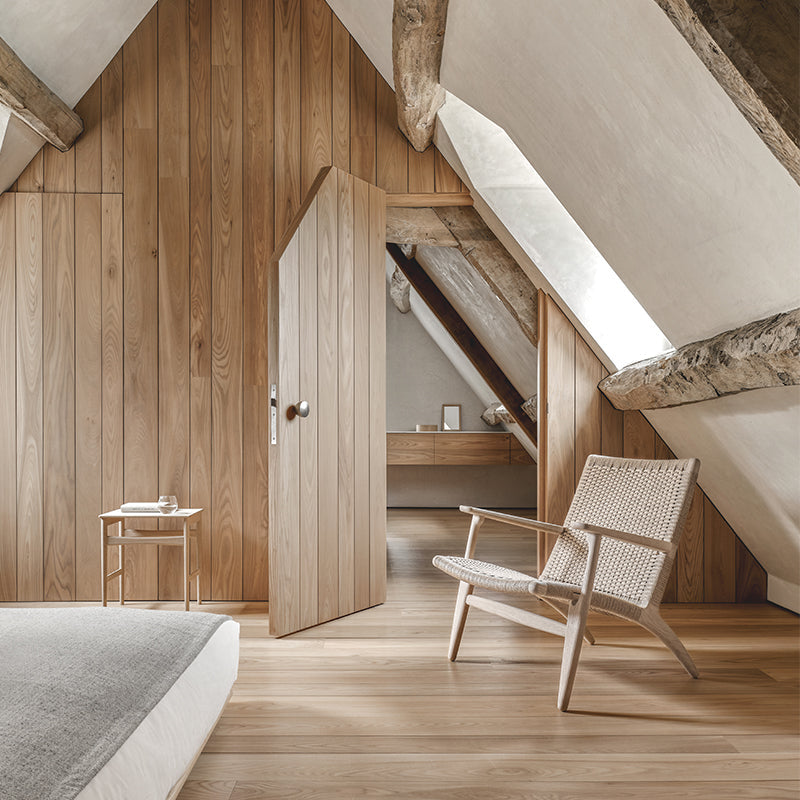 carl hansen ch25 oak lounge chair in luxury scandi style bedroom with oak beams