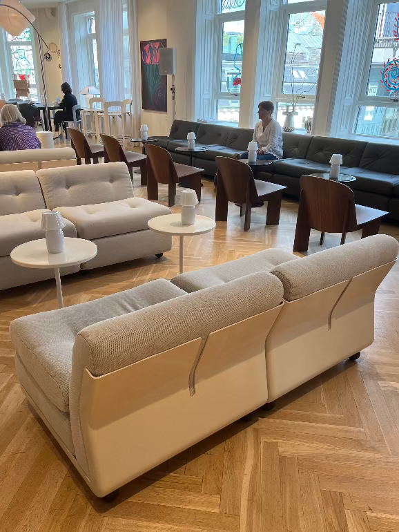Modern living room with beige sofas, wooden coffee tables, and large windows. Hay Amanta sofa launch at 3 days of design 2025 Copenhagen