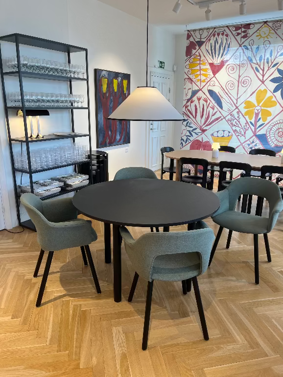 Dining area with Hay Annex round table and Layout dining chairs in a room with colorful wall art. hay store Copenhagen 3DD 2025