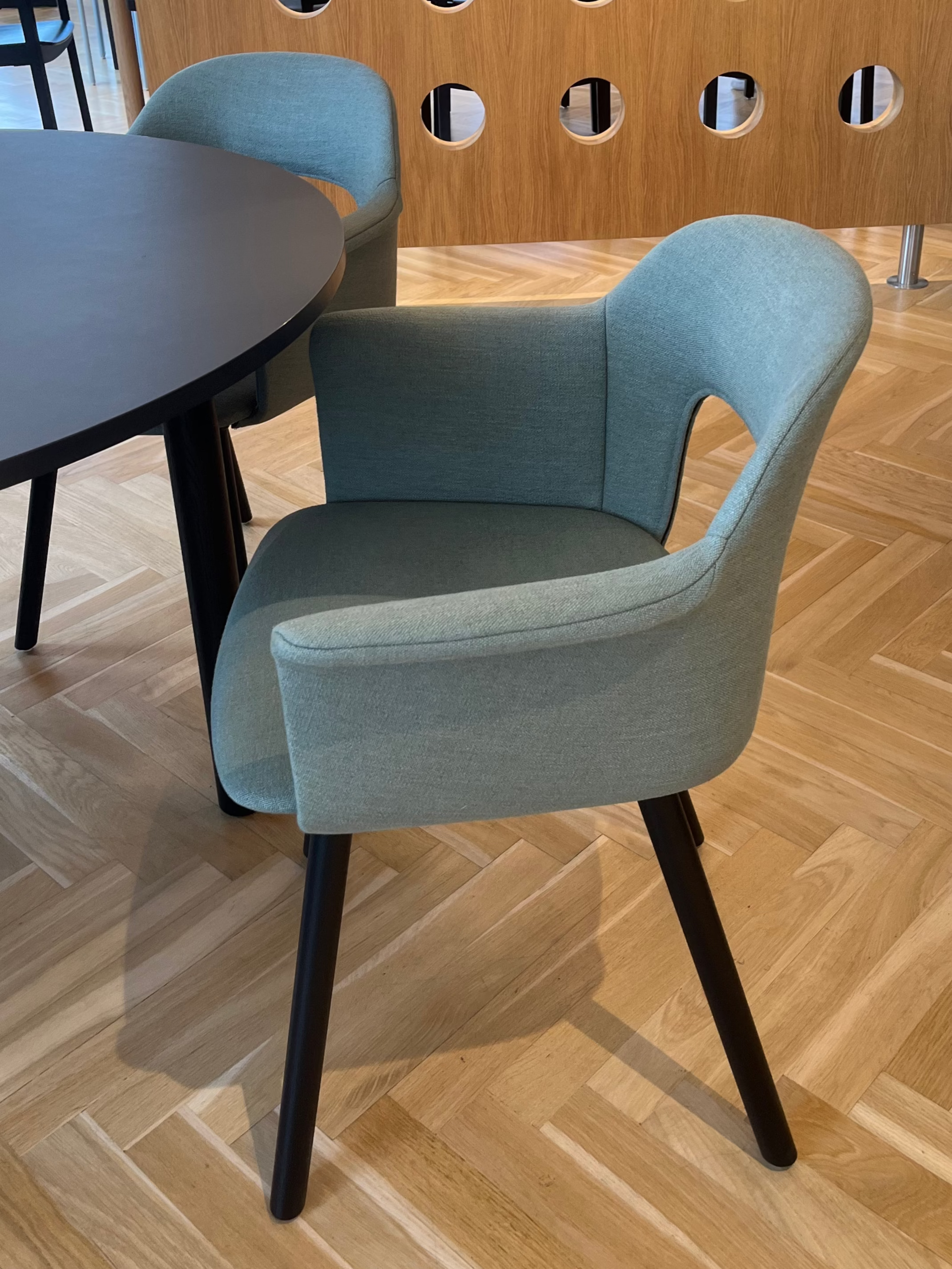 Hay Layout upholstered Blue armchair with black legs on a wooden floor in an indoor setting. 3DD 2025 Copenhagen launch.