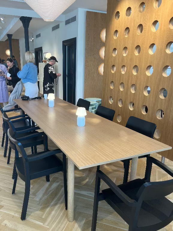 Hay Annex Long wooden table with black dining chairs in a modern interior setting at the HAY store during 3 daysofdesign in Copenhagen 2025