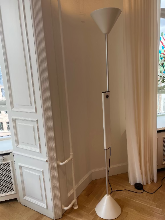 Hay Twist White floor lamp in a room with wooden flooring and a window.