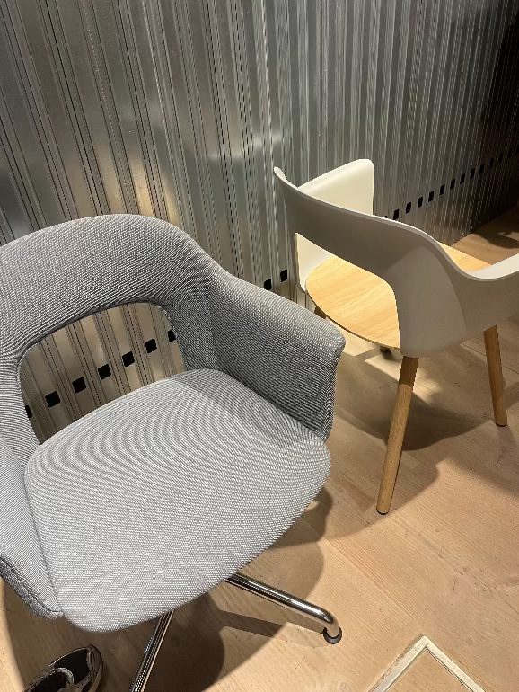 Hay Layout 234 armchair and white chair with wooden legs on a tiled floor. Hay 3dd 2025 by Julien Renault