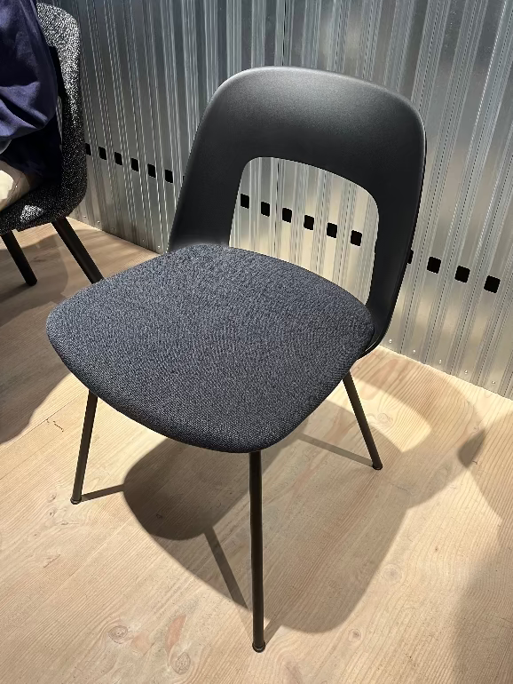 Hay Layout Gray dining chair with black legs on a wooden floor against a striped wall.