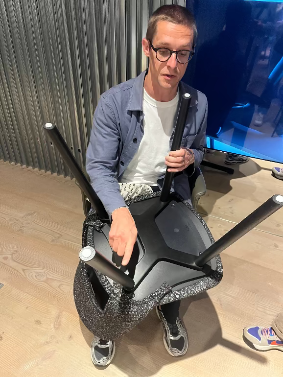 Furniture Designer Julien Renault demonstrating the way the legs are fixed on his new Layout chair for HAY. 3DD 2025 Copenhagen