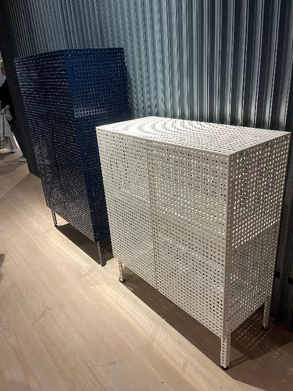 Hay' new Perforated Metallic cabinet with woven design against a textured wall.