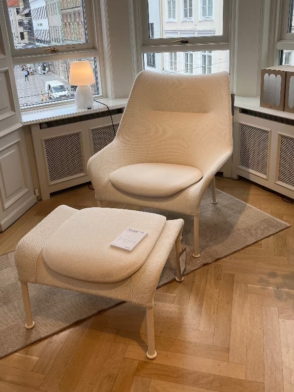 Hay's O2 White armchair and ottoman in a room with large windows and a view of buildings outside. Hay House copenhagen 2025