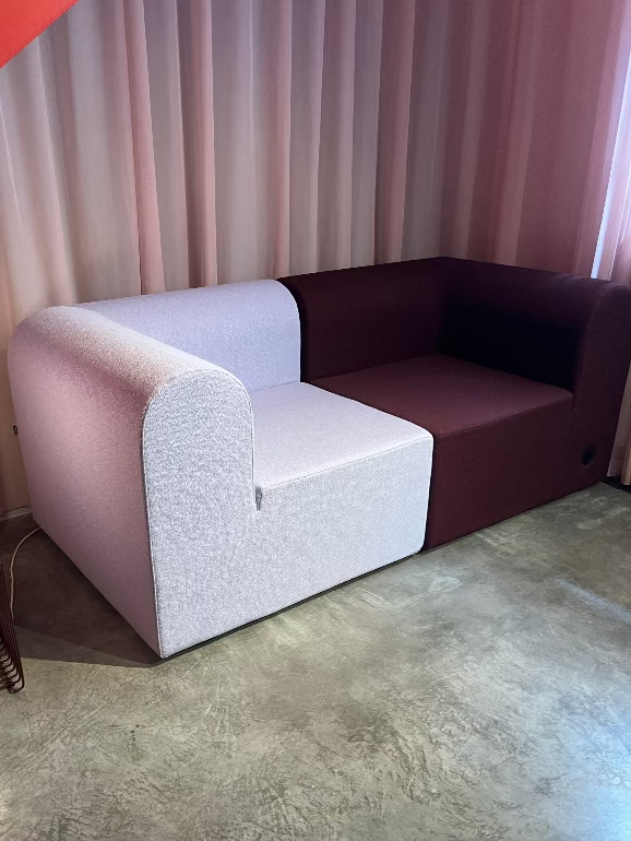 Modern sofa with a unique design in a room with curtains and a lamp. New re-edition by Montana of the Paradigm sofa by Erik Rasmussen.