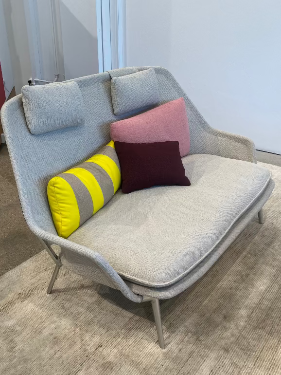 Modern gray sofa with colorful cushions in a room setting. New Slow Sofa by Vitra at 3DD copenhagen