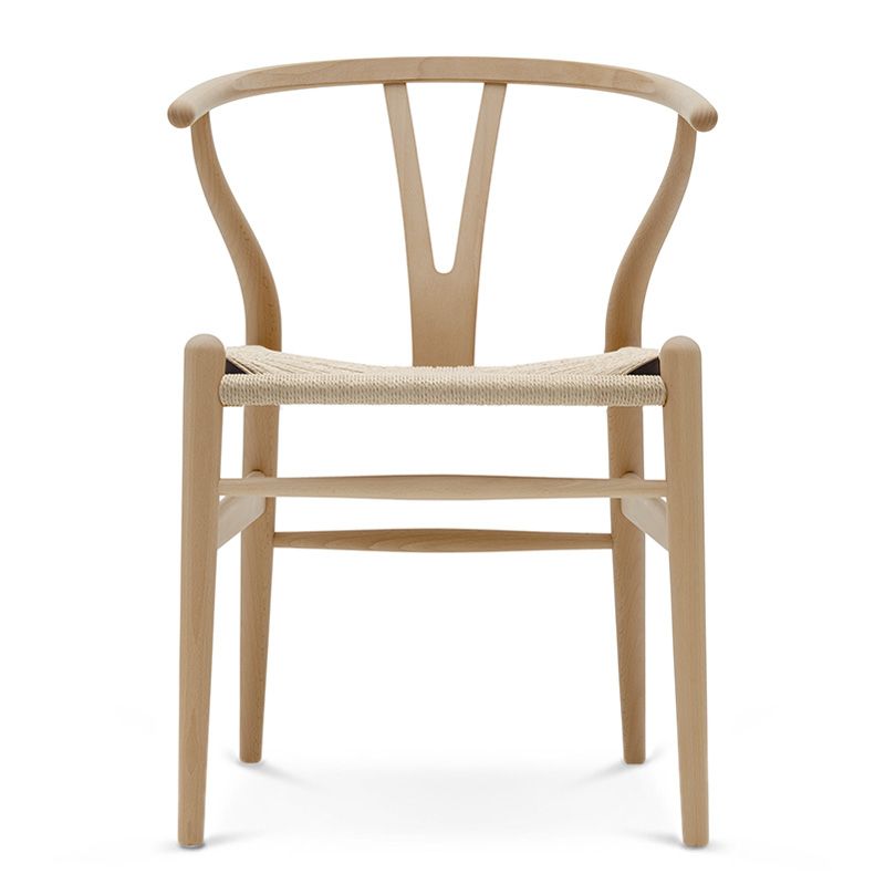 A beech lacquer Carl Hansen CH24 Wishbone dining chair with a paper cord seat and wooden frame.