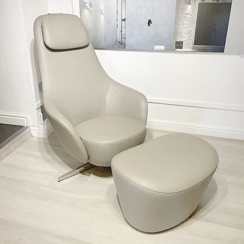 A B&B Italia Harbor Laidback swivel reclining armchair with an attached ottoman, displayed in a room setting. Ex-display chair with great discount on it. Innes