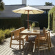 Skagerak Cadence Outdoor Bench, Dining Table and Dining Chair in Untreated Teak — lifestyle, with Messina Umbrella