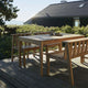 Skagerak Cadence Outdoor Bench in Untreated Teak — lifestyle, with Cadence Outdoor Dining Table, Cadence Outdoor Dining Chair