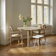  Skagerak Hven Round Oak Dining Table and Hven Oak Dining Armchair — lifestyle