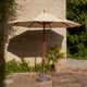 Skagerak Messina Parasol in Golden Yellow Stripe — lifestyle, with Skagerak Capri Umbrella Foot