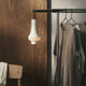 Louis Poulsen Tomoshi Portable Lamp in White — lifestyle, clothes rack, dim level 5%