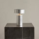 Audo Column Portable Table Lamp in Brushed Aluminium — studio, with Plinth Tall