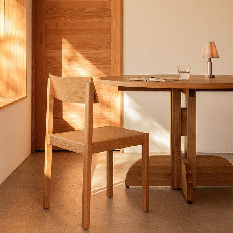 Audo Mauro Dining Chair Wood Veneer Seat — lifestyle, with Audo Puffin Dining Table and Admiral Portable Table Lamp