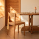 Audo Mauro Dining Chair Wood Veneer Seat — lifestyle, with Audo Puffin Dining Table and Admiral Portable Table Lamp