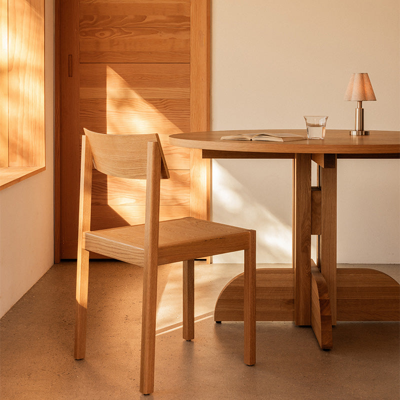 Audo Puffin Dining Table Round — lifestyle, with Mauro Dining Chair and Admiral Portable Table Lamp