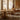 Audo Puffin Dining Table Round — lifestyle, with Mauro Dining Chair Paper Cord and Admiral Portable Table Lamp