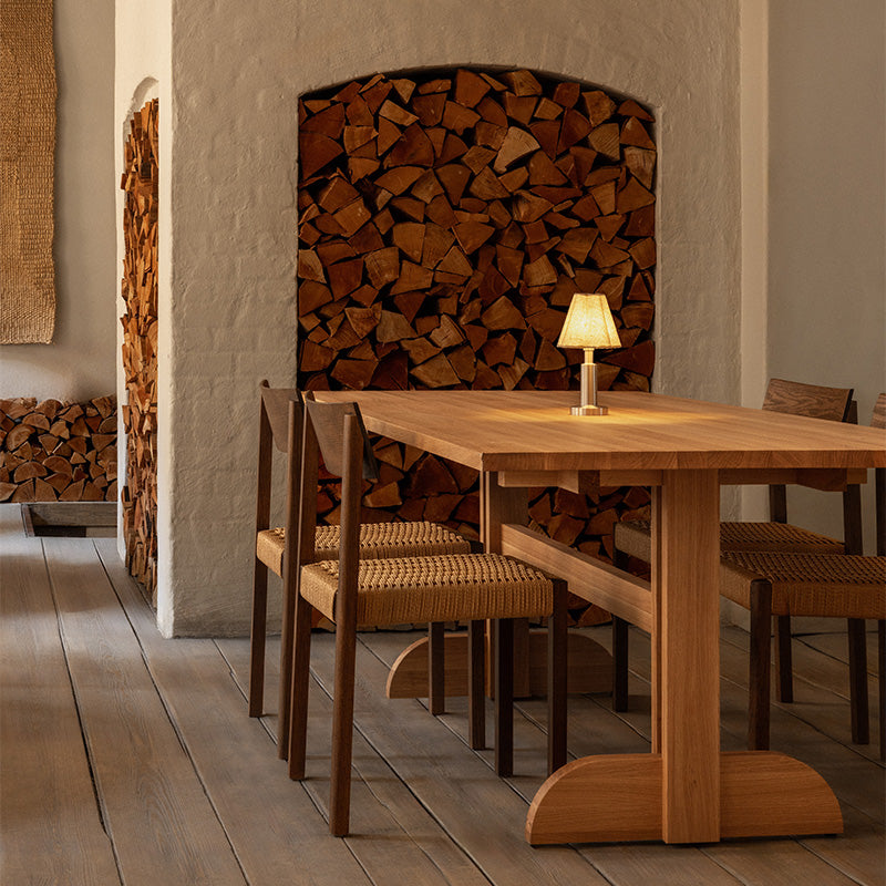 Audo Mauro Dining Chair Paper Cord Seat — lifestyle, detail, with Audo Puffin Dining Table and Admiral Portable Table Lamp