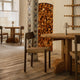 Audo Puffin Dining Table Round — lifestyle, with Mauro Dining Chair Paper Cord and Admiral Portable Table Lamp