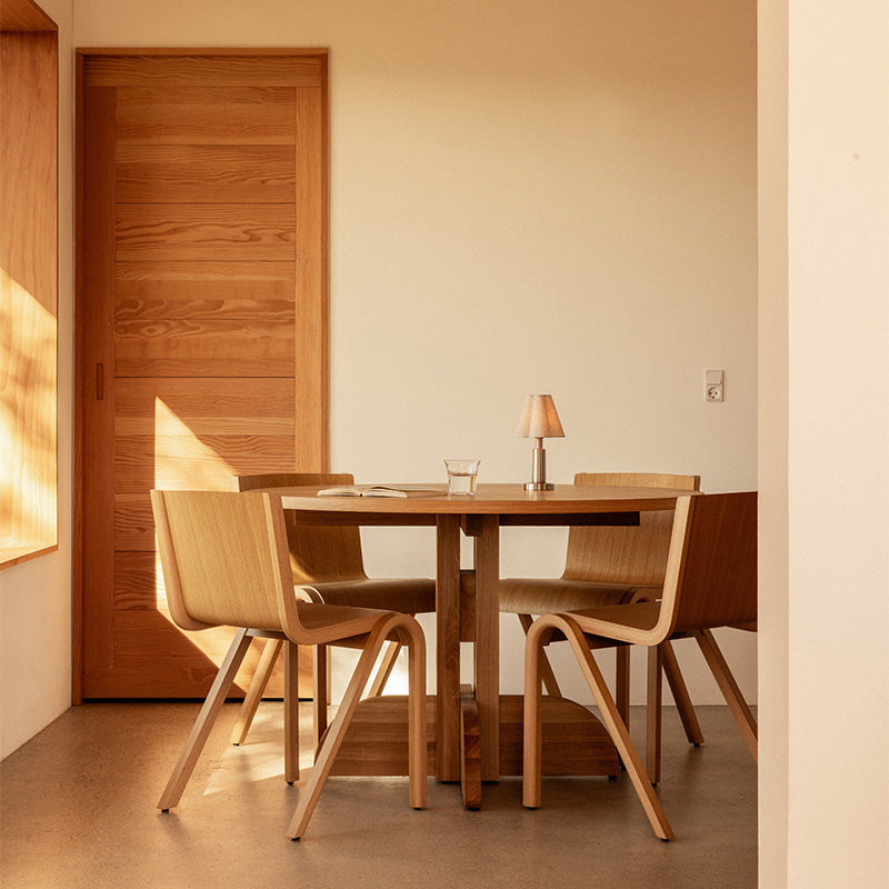 Audo Puffin Dining Table Round — lifestyle, with Ready Dining Chair and Admiral Portable Table Lamp