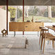 Carl Hansen CH825 Credenza in Oak Oil, steel base — lifestyle, with CH322 Dining Table, CH20 Chair
