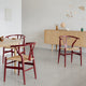 Carl Hansen CH24 Wishbone Chair in Beech Falu, Natural Cord — lifestyle, with CH337 in Oak Soap and CH825 in Oak Oil