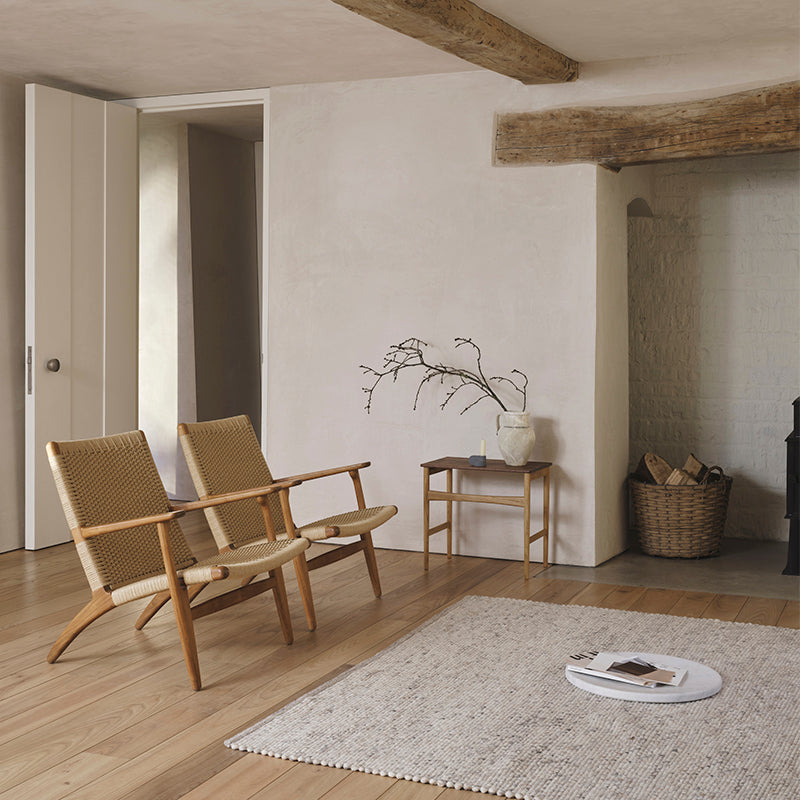 Carl Hansen CH25 Easy Chair in Oak Oil with CH004 footstool — lifestyle shot