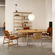 Carl Hansen BM0121 Extendable Round Dining Table styled with PK1 Chair and Carl Hansen BM1106 Huntsman Chair — lifestyle shot