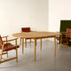 Hansen BM0121 Extendable Round Dining Table styled with Carl Hansen BM1106 Huntsman Chair — lifestyle shot