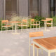 Skagerak Pelagus Outdoor Dining Armchair and Café Table in Light Ivory — lifestyle, hospitality setting