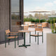 Skagerak Pelagus Outdoor Dining Armchair in Hunter Green — lifestyle, with Pelagus Cafe Table