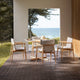 Carl Hansen E022 Embrace Outdoor Dining Table in Teak, D110cm — lifestyle, with E008 Outdoor Dining Chair