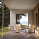 Carl Hansen E022 Embrace Outdoor Dining Table in Teak, D110cm — lifestyle, with E008 Outdoor Dining Chair