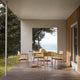 Carl Hansen E008 Embrace Outdoor Dining Chair in Teak — lifestyle, with E022 Outdoor Dining Table