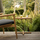 Carl Hansen E023 Embrace Outdoor Lounge Table in Teak — lifestyle, with E018 Outdoor Lounge Chair