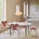 Fritz Hansen 3130 Grand Prix Dining Chair in pink — lifestyle, dining room with Superellipse table and Clam pendant