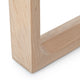 Close-up of a light natural wood picture frame corner showing the grain and beveled edges on a white background.