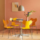 Fritz Hansen 3130 Grand Prix Dining Chair in yellow — lifestyle, dining room with A825 table and Suspence pendant