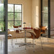Fritz Hansen 3208 Lily Armchair in Walnut veneer — lifestyle, dining room with A825 table and Clam Portable lamp