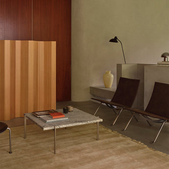 Fritz Hansen PK22 Lounge Chair in Haze Dark Brown — lifestyle, with PK111 in Oregon Pine and PK61 in Granite Grey