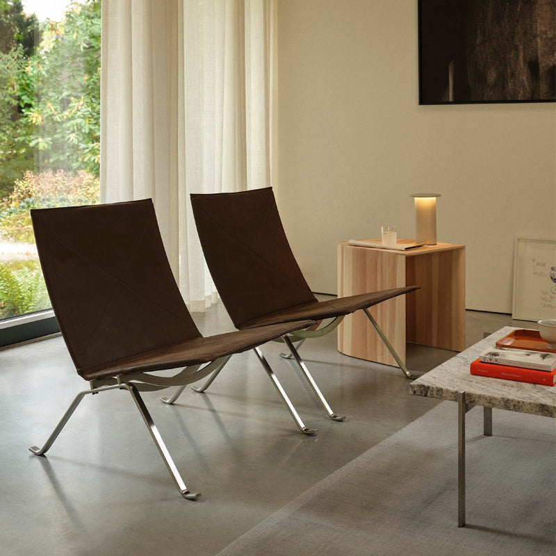 Fritz Hansen PK22 Lounge Chair in Haze Dark Brown — lifestyle, with PK61 in Granite Grey and Taburet in Pine