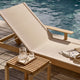Skagerak Pelagus Sunbed in Sand — lifestyle, with armrest and Cutter Stool