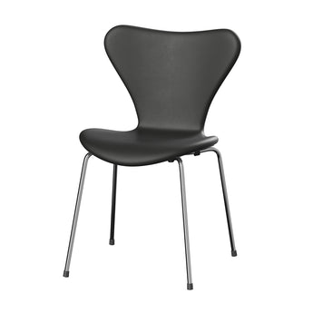 A modern black leather upholstered chair with a curved backrest and slim metal legs, shown against a plain white background.