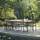 Skagerak Pelagus Outdoor Dining Armchair and Dining Chair with Extendable Dining Table in Hunter Green — lifestyle