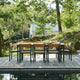Skagerak Pelagus Outdoor Dining Armchair and Dining Chair with Extendable Dining Table in Hunter Green — lifestyle