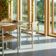 Skagerak Pelagus Outdoor Dining Armchair and Dining Chair with Extendable Dining Table in Light Ivory — lifestyle